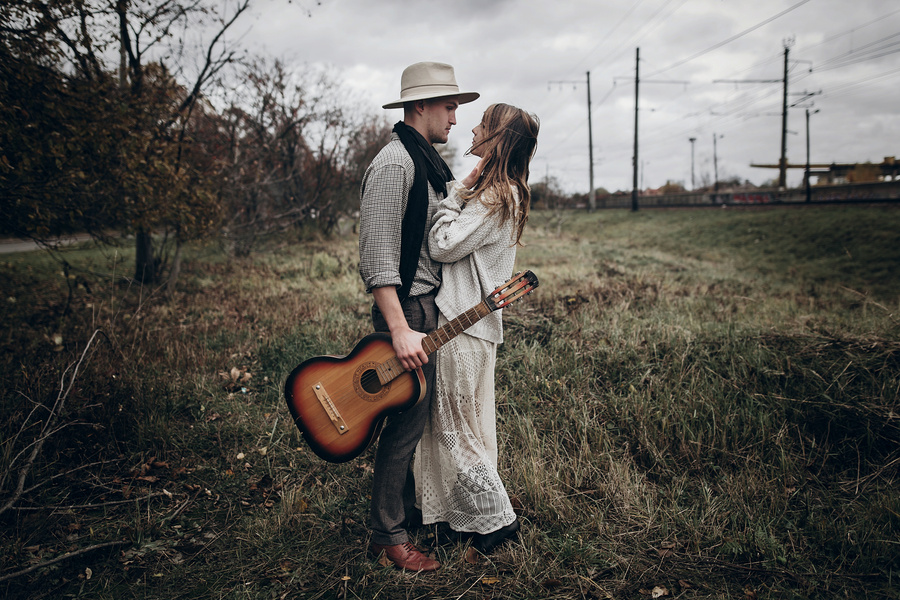 Rustic Wedding Concept. Boho Gypsy Woman and Man with Guitar Pos